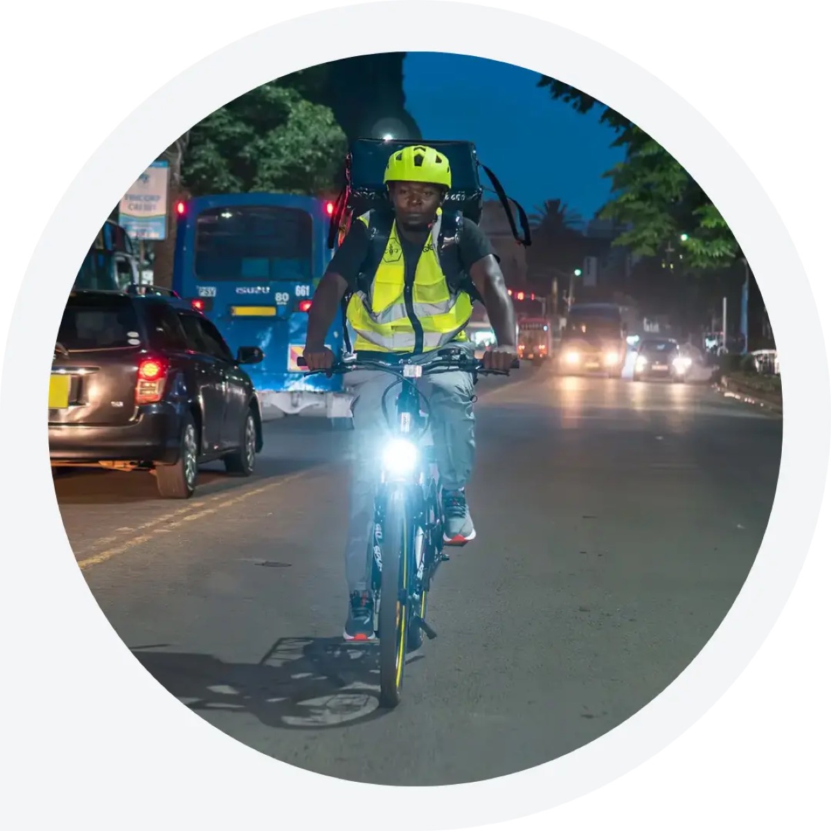 eBee rider on an electric delivery bicycle in Nairobi at night