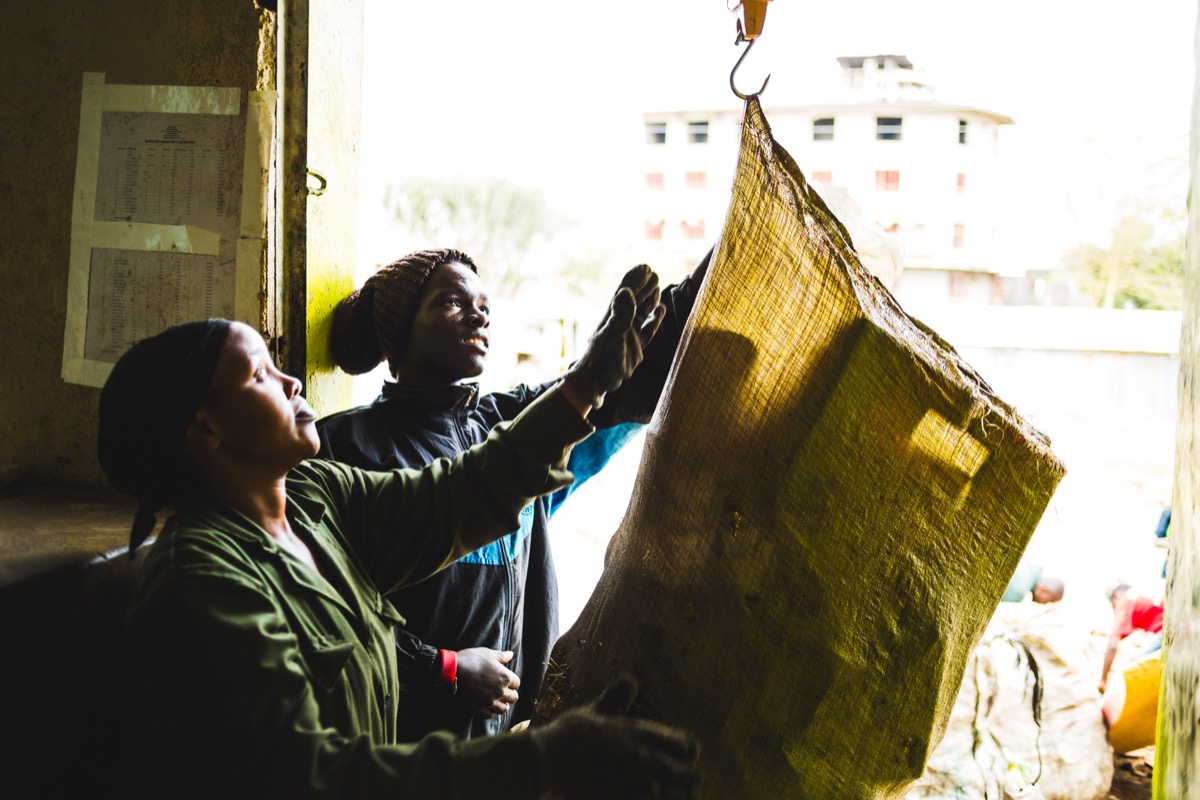 Workers weighing a sack of sourced plastic at a Mr Green Africa trading hub in Nairobi